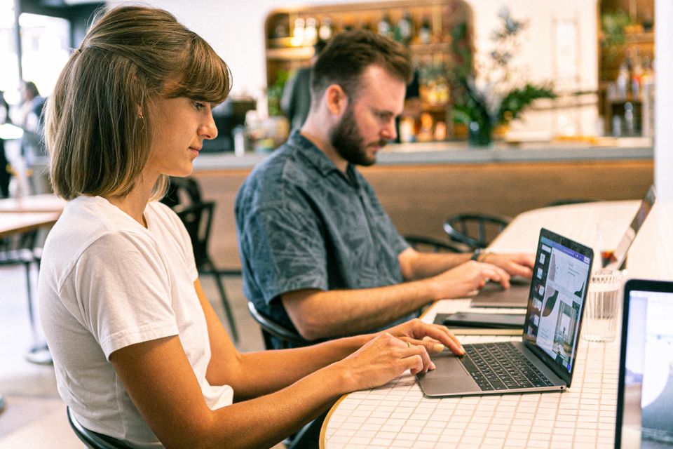 Engineers working on laptops in a modern office